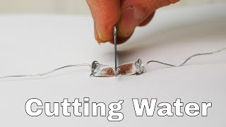 Superhydrophobic Knife Slices Water Drops in Half [upl. by Noyahs]